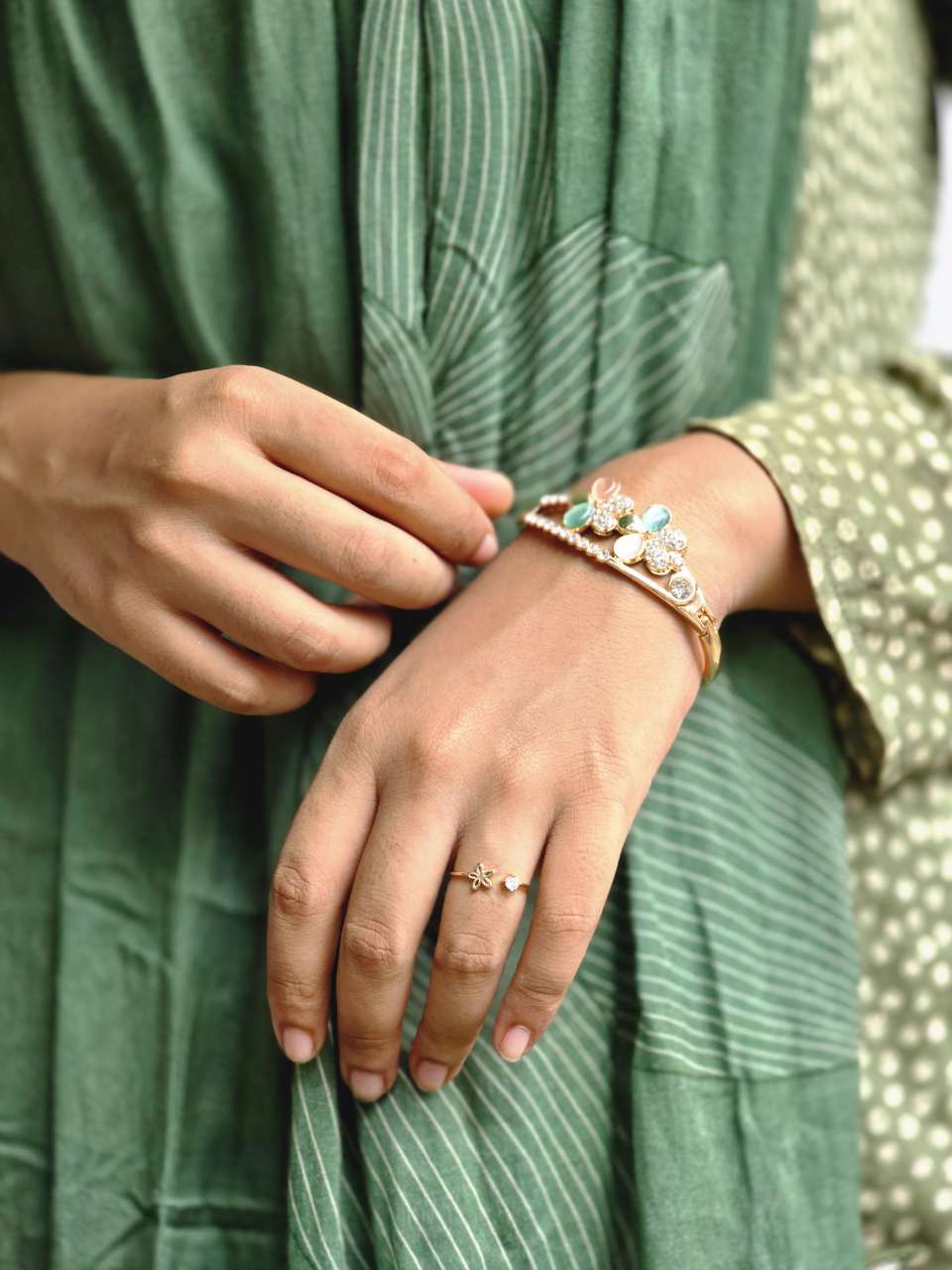 gold-plated floral kada bangle (or hinge-lock cuff bracelet).